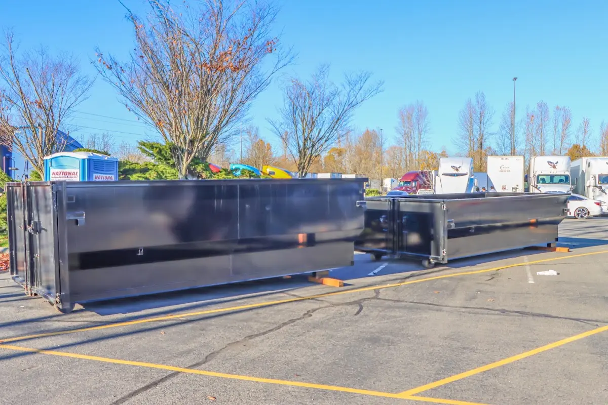 Professional dumpster rental service with roll-off container on residential driveway in Sandwich